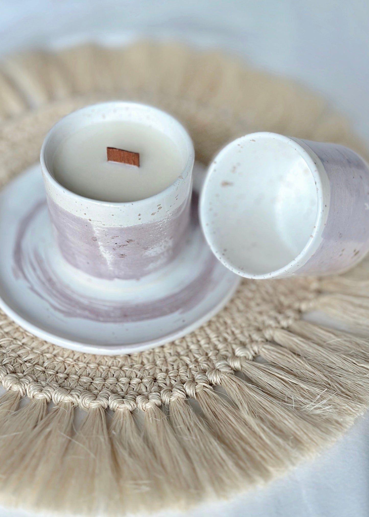 Ceramic cup and saucer on a woven placemat with a white background